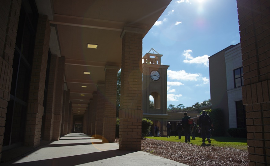 south university savannah campus walkway with students walking to the clock tower